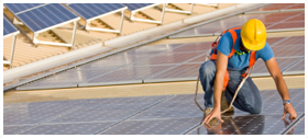 a worker on roof installing a solar panel