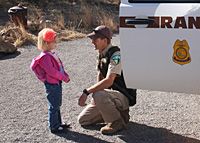 Photo of young girl talking to ranger