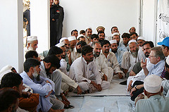 A/S Schwartz seated with Pakistani Men