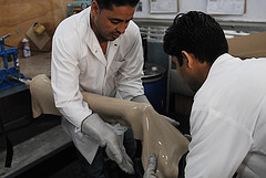 Two men making prosthetic leg