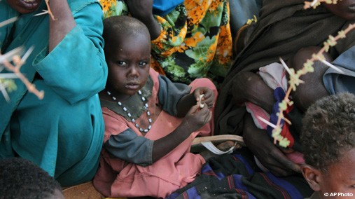 A Somali child who recently arrived at a refugee camp in Dolo, Somalia sits under a tree while waiting for food rations on July 18, 2012. [AP Photo]