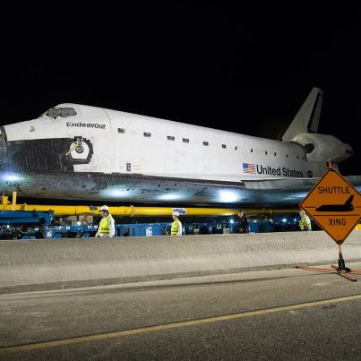 Photo: Space Shuttle Endeavour Move

The space shuttle Endeavour is seen atop the Over Land Transporter (OLT) after exiting the Los Angeles International Airport on its way to its new home at the California Science Center in Los Angeles, Friday, Oct. 12, 2012.  Endeavour, built as a replacement for space shuttle Challenger, completed 25 missions, spent 299 days in orbit, and orbited Earth 4,671 times while traveling 122,883,151 miles. Beginning Oct. 30, the shuttle will be on display in the CSC’s Samuel Oschin Space Shuttle Endeavour Display Pavilion, embarking on its new mission to commemorate past achievements in space and educate and inspire future generations of explorers. Photo Credit: (NASA/Bill Ingalls)