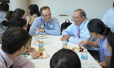 Dr. John I. Gallin sitting at a table with a group of new clinical fellows