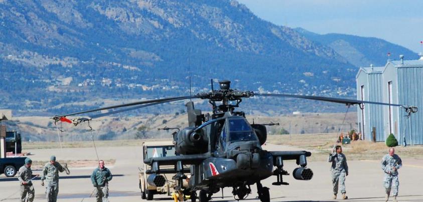 Photo: AH-64 Apache helicopter maintainers walk an aircraft to the hangar at U.S. Army Fort Carson Oct. 4. Nearly 100 support personnel from the 10th Combat Aviation Brigade made it possible for the unit's aviators to conduct High Altitude Mountainous Environment Training in the Colorado Rocky Mountains.