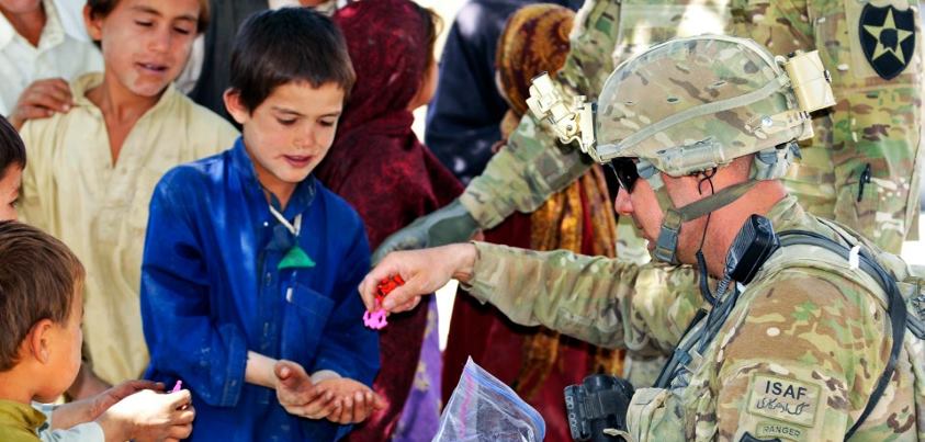 Photo: U.S. Army Command Sgt. Maj. Joseph Dallas, the command sergeant major of 5th Battalion, 20th Infantry Regiment, 2nd Infantry Division (Official Page), gives toys to Afghan children during Operation Southern Fist in Afghanistan, Sept. 30. U.S. Army photo by Staff Sgt. Brendan Mackie