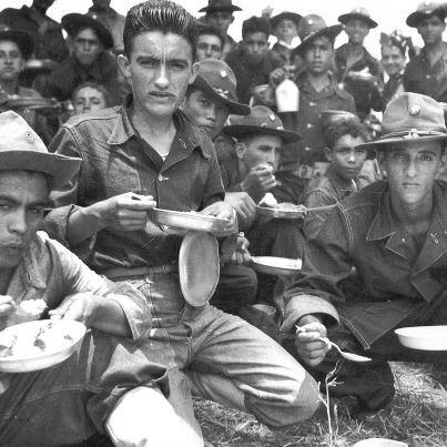 Photo: Soldiers of 65th Infantry after an all day schedule of maneuvers at Salinas, Puerto Rico, August 1941.