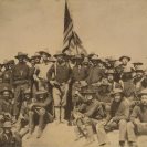 Photo: Roosevelt's "Rough Riders" pose for a group photo while proudly displaying the American flag.