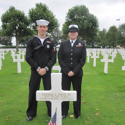 Photo: Petty Officer Clinton T. Hobbs, accompanied by Petty Officer Jamie N. Morgan, visits the grave of his great uncle Pvt. Russell L. Price, Jr. at Netherlands American Cemetery.