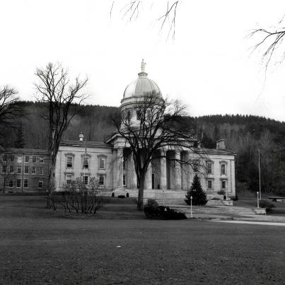 Photo: The Vermont State House, located in Montpelier, is the state capitol of Vermont and the seat of the Vermont General Assembly. The current structure was designed by architect Thomas Silloway (1828–1910). The Doric portico, the main ceremonial entrance, houses a granite statue of Ethan Allen. Ethan Allen was a founder of Vermont and commander of the Green Mountain Boys, an early Vermont military infantry active during the Vermont Republic, (1777–1791). Vermont's reputation for popular government is represented by the State House's nickname "the People's House." While its primary use is as the house of the legislative branch of Vermont government, it has from its beginnings also functioned as a living museum and state cultural facility. This photograph was taken in November of 1962 when the building was being prepared to begin serving as a fallout shelter for the citizens of Montpelier. RG 077, Records of the U.S. Army Corps of Engineers, Civil Defense Photographs.
