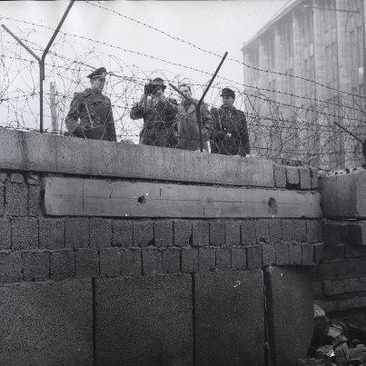 Photo: On this day in 1990, West Germany and East Germany ended 45 years of postwar division, declaring the creation of a new unified country. The Berlin Wall, which had symbolized the division between East and West, would begin to be taken down. This picture was taken in 1962 and shows East German police photographing a section of the Berlin Wall where an unknown assailant had attempted to blow a hole in a section of the wall in Berlin Item from Record Group 306: Records of the U.S. Information Agency, 1900 - 2003