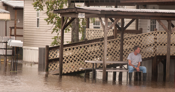 A resident of Pointe a la Hache, LA, sits on the stairs of his home that was flooded in the aftermath of Hurricane Isaac