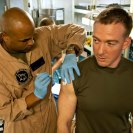 Photo: 121009-N-OR551-059 GULF OF ADEN (Oct. 9, 2012) Hospital Corpsman 1st Class Jimmie Davis administers an influenza vaccination to 1st Lt. Sean McCarragher, assigned to the 24th Marine Expeditionary Unit, in the medical ward aboard the multipurpose amphibious assault ship USS Iwo Jima (LHD 7). Iwo Jima Amphibious Ready Group and embarked 24th Marine Expeditionary Unit are deployed in support of maritime security operations and theater security cooperation efforts in the U.S. 5th Fleet area of responsibility. (U.S. Navy photo by Mass Communication Specialist 2nd Class Morgan E. Dial/Released)