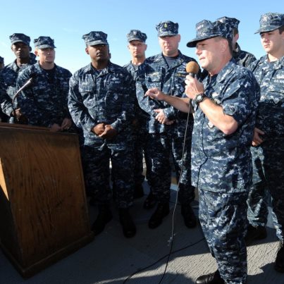 Photo: Adm. Bill Gortney congratulates the crew of USS Bainbridge (DDG 96) after officially presenting them with the Arleigh Burke Award for Surface Warfare Operational Excellence. (U.S. Navy photo by Mass Communication Specialist 1st Class Phil Beaufort/Released)