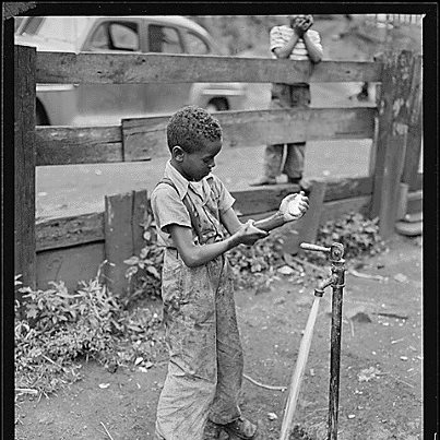 Photo: Today is Global Handwashing Day, and we thought this picture was a great example of some historic hygiene. Look at the giant piece of soap in the little boy's hand! 

The original caption reads: "Son of James Robert Howard washes his hands before supper. Mr. Howard installed running water in his kitchen but dirty hand washing is usually done at the front yard faucet. Gilliam Coal and Coke Company, Gilliam Mine, Gilliam, McDowell County, West Virginia., 08/13/1946 "