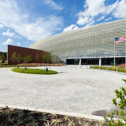 Photo: The NOAA Center for Weather and Climate Prediction is a candidate for silver certification by the U.S. Green Building Council’s LEED™ Green Building Rating System. It was built using materials with recycled and local content, and highly efficient glass. Sunshades have been incorporated into the design on the south side of the building to optimize energy performance.  Two-thirds of the roof surface is “green roof” covered with low growing plants for better insulation and protection. Rainwater bio-retention areas and a storm water cistern collect water for irrigation, and a four-story rainwater waterfall efficiently drains the non-green roof.

Details...

http://1.usa.gov/Q9xoxr

(Photo: University of Maryland)