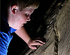 boy looks into the vastness of  Mammoth Cave