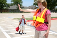 A crossing guard helps a child