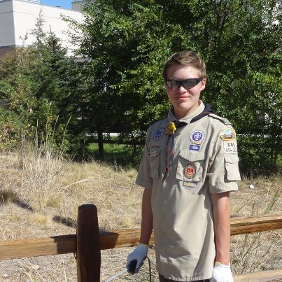 Photo: Monument Fence Gets Boost from Boy Scouts

On a warm, sunny Saturday day in September, the split-rail fence at the National Firefighters' Monument got a badly needed boost.
About 20 people affiliated with Boy Scout Troop #315 turned out to support Michael Schone fulfill one of the final requirements needed to obtain the rank of Eagle. Each Eagle Scout candidate must develop, organize, oversee and complete a project that benefits the community before receiving the honor.

Michael’s project came in two stages: First, prep the fence by pressure-washing one week, and then staining it the next.
Gaining approval for a suitable project by the Boy Scouts of America (BSA) organization was one of the more difficult chores for Michael. The BSA has strict standards for Eagle Scout project proposals and Michael approached several community organizations, none of which had a suitable project for him. 
"Just finding a project was a challenge," he says. "We got turned down a lot."

He learned of the need through a circuitous route. First came Michael's dental hygienist, Brian Halle, who was aware of the need for an Eagle project. Next came one of the dentist's patients, Tim Murphy, BLM assistant director at NIFC. That led to a call from Tim Murphy to Einar Norton, NIFC's supervisory engineer.  The discussion in the dentist's chair was the catalyst for Michael getting in touch with Einar. After that, the dots connected quickly. 

Behind every Eagle Scout is usually a determined mother. That was certainly the case for Michael.
"It feels wonderful to finally complete this journey toward the Eagle; I'm very proud of him," says Noel Schone, who modestly described her role as, "Keeping him focused and reminding him.  I’d call it 'gentle persuasion.'"

The project was a family affair. Along with his mother, Michael's father, Ryan, brother Steven (also an Eagle Scout) sister Heather, uncles, cousins and grandparents all supported him.
  
Overall, he estimates about 95 hours of work were needed to rehab the 1,065-foot fence. The fence was in need of help. The last time it was pressure-washed and stained, it's believed, was in 2004, when another Eagle Scout candidate took on the chore.

"When Michael and I came to NIFC and met with Einar, we walked around the monument," Noel recalls. "I struggled to keep my eyes dry as I saw the names of the men and women there who have sacrificed their lives fighting fires. It's very humbling and I'm grateful this monument exists to remember these heroes. We knew then that this was an amazing project, not just staining a fence."

Einar Norton agrees that the work was worthwhile.
"Michael's Eagle project is not only a great way to spruce up the firefighter monument's appearance, but it is also a very positive way to connect with the local community and bring awareness to the individuals who have lost their lives while serving the public," he says.
The NIFC Employees' Association provided treats for the volunteers. NIFC campus maintenance supplied the materials.
Michael is a freshman at Centennial High School. Among his interests outside of scouting are music (he plays the trumpet in the marching band) and art (he wants to be an animator someday and make children’s films.)
"He loves art," says Noel. "He's happiest when he has a paintbrush in his hand."
And in that sense, Michael Schone's Eagle Scout project was a perfect fit for him.