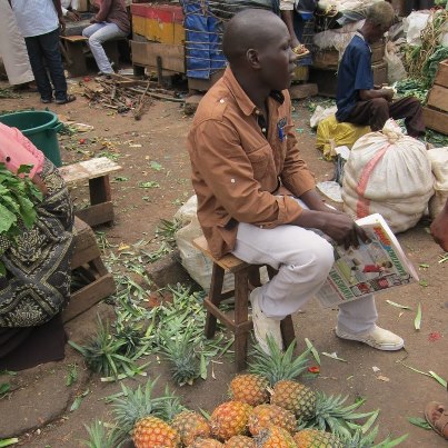 Photo: Pineapple sales in an open produce market in Kampala, Uganda