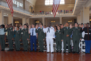 Members of the United States Armed Forces are sworn in as citizens at Ellis Island
