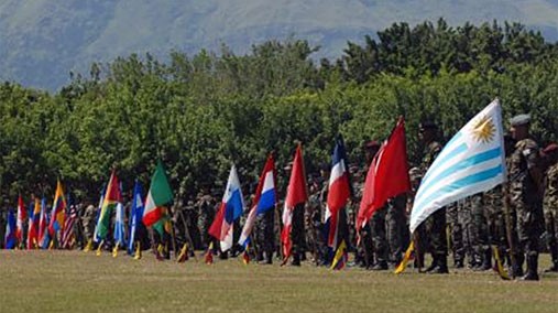 Twenty-one special operations forces teams stand ready on the parade field displaying their nations colors during the opening ceremony at the Colombian National Training Center at Fort Tolemaida on June 6, 2012. [Photo by 107th Mobile Public Affairs Detachment]