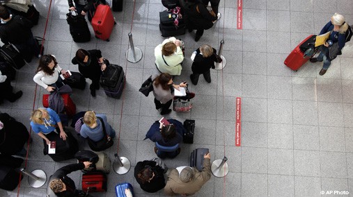 Travelers queue at the Duesseldorf International Airport on March 27, 2012. in Duesseldorf, Germany. [AP File Photo]