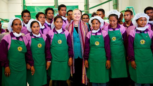 U.S. Secretary of State Hillary Clinton smiles with workers from the USAID founded Cooperativa Cafe Timor in Dili, Timor-Leste, September 6, 2012. [UNMIT photo by Bernardino Soares]
