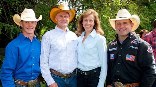 Calgary Consul General Laura Lochman and husband Joe Schaefer, center, welcome American cowboys Zach Phillps, left, and Kelly Timberman, right, to Calgary, Canada, in July 2012. [State Department photo/ Public Domain]