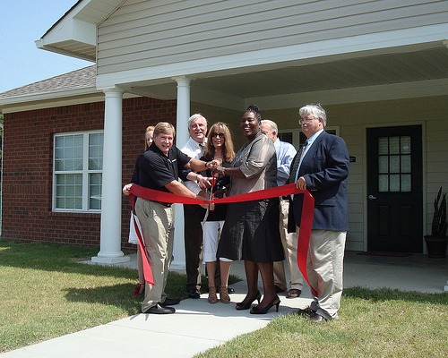 Mississippi Rural Development State Director Trina George (Third from right) helps cut a ribbon marking the opening of Rosedale Estates.