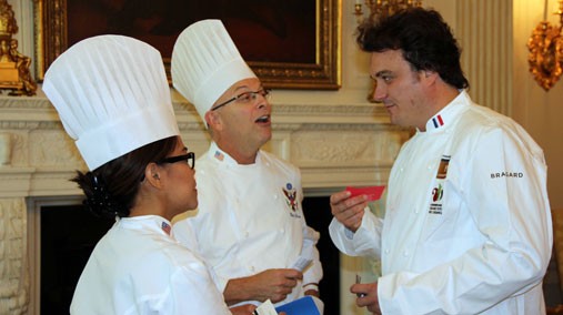 Culinary Diplomacy International Visitor Leadership Program (IVLP) participant Armand Arnal of France speaks White House Executive Chef Cristeta Comerford and Pastry Chef William Yosses at the White House in Washington, D.C., September 2012. [State Department photo/ Public Domain]