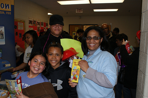 (from L to R) Kimberly Mejia and Germany Ray, both Oxon Hills Elementary School students, Felicia Thompson and Nita Ray stop by the FSIS food safety exhibit to obtain food safety information, educational materials and promotional items during the Oxon Hills Health Extravaganza on March 23, 2011.