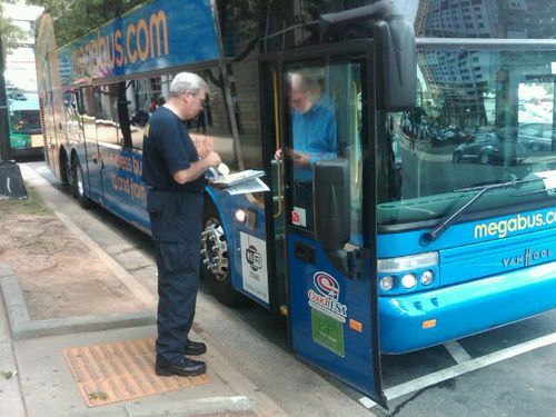 Inspecting a curbside bus