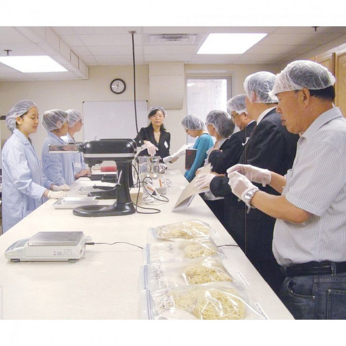 A Chinese delegation observes methods used to prepare noodles with dry bean flour during a reverse trade mission site visit to the University of Nebraska-Lincoln. The Foreign Agricultural Service’s (FAS) Agricultural Trade Office (ATO) in Beijing recently partnered with the U.S. dry edible bean industry to launch a program that aims to pack more protein into Chinese diets. (Courtesy University of Nebraska-Lincoln)