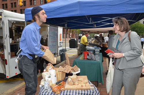 Agriculture Deputy Secretary visits a vendor at Cleveland, Ohio's Downtown Farmers Market at Public Square.  With the help of Farmers Market Promotion Program funds, farmers markets and other organizations will strengthen the connection between farmers and their communities and increase access to fresh, healthy foods.