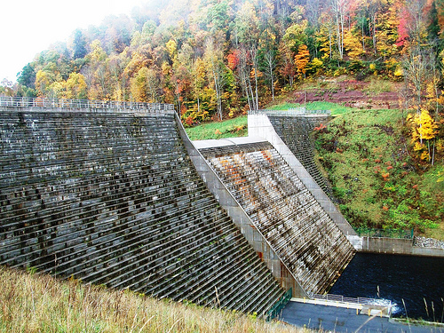 The Elkwater Fork Dam with fall foliage. A paved accessible fishing area below the dam provides an area for those with physical impairments to fish in the stilling basin.