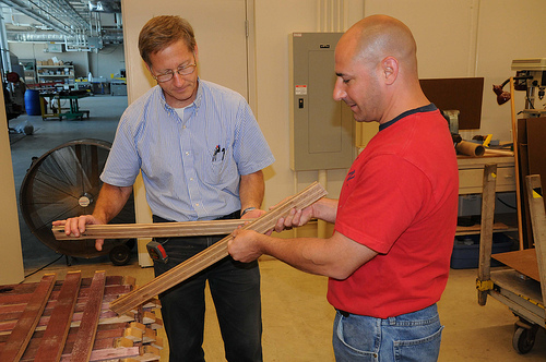 Forest Products Lab engineer John Hunt (left) and Jubliee Flooring owner Joe Triglia inspect flooring milled from discarded wine barrel staves.