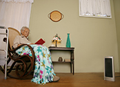 senior adult in rocking chair by space heater