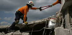 Red Cross disaster responder at site of earthquake searching for survivors