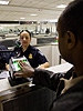 A traveler arriving at Washington Dulles International Airport Monday uses the new US-VISIT mechanism that records all 10 fingerprint images.