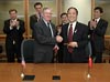 U.S. Customs and Border Protection Commissioner W. Ralph Basham congratulates Mu Xinsheng, Minister of Customs for the General Administration of Customs of the People’s Republic of China, after the signing of the agreement as officials from both countries look on.