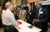 CBP Commissioner W. Ralph Basham talks with CBP recruiters at the agency’s recent job fair.