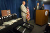 At a press conference announcing the publication of the WHTI Land and Sea Notice of Proposed Rulemaking, Department of Homeland Security Secretary Michael Chertoff gestures towards sample fraudulent documents provided by Immigration and Customs Enforcement.