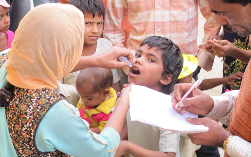 Photo: During a campaign in India, a child’s pinkie finger is marked by a vaccinator to signify that the child received the polio vaccine.