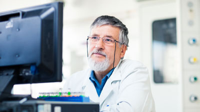 Researcher sitting at a computer.