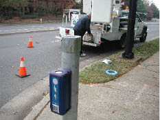 Photo shows a new APS installed on a short stub pole at the departure curb.