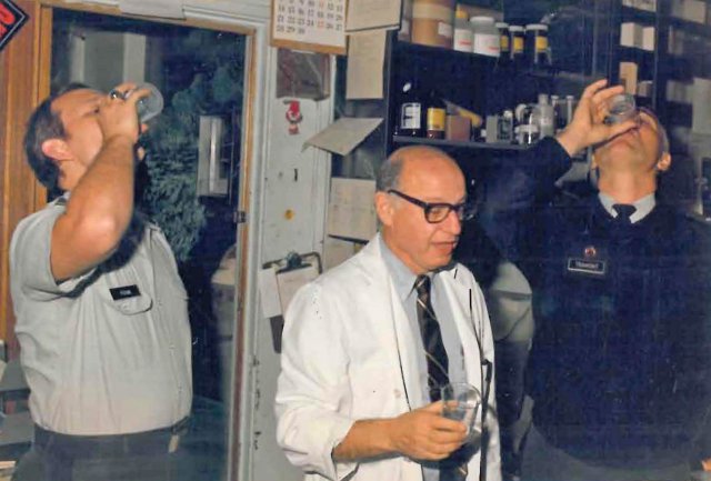 Dr. Edmund C. Tramont (left) and two colleagues drink an experimental vaccine against shigella at Walter Reed Army Medical Center, Washington, D.C., about 1988.