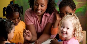 woman teacher with kids around a table