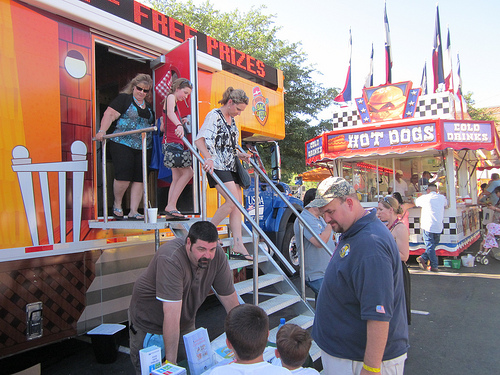 Visitors exit the Food Safety Discovery Zone at the Fiesta Oyster Bake, a part of the larger Fiesta San Antonio. Craig Bookout, a Public Health Veterinarian in FSIS’ Dallas district, speaks to two children about ways to prevent foodborne illness. The FSIS Food Safety Discover Zone was in Fiesta, San Antonio April 20-21, 2012.