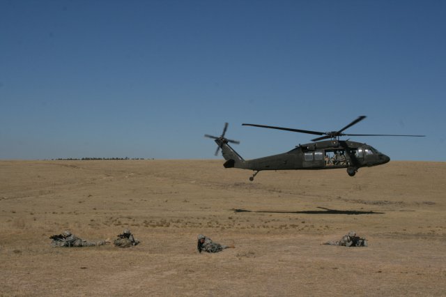 Soldiers from the 663rd Ordnance Company, 242nd Explosive Ordnance Disposal Battalion, 71st Ordnance Group (EOD), cover their comrades as a Black Hawk helicopter takes the team to another training lane, Oct. 10, 2012.