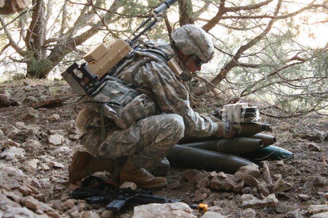 Sgt. Jason Due, 663rd Ordnance Company, 242nd Explosive Ordnance Disposal Battalion, 71st Ordnance Group (EOD), tapes blocks of C-4 explosives to a weapons cache during an Oct. 10, 2012, training lane at Camp Guernsey, Wyo. The company completed nine training lanes, based on real-world scenarios, Oct. 10-11. The Soldiers also completed land navigation training, a convoy live fire and honed basic Soldier and EOD skills throughout their time at Camp Guernsey, Oct. 1-18.